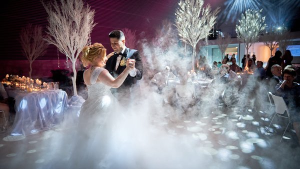 Hochzeitstanz im Nebel mit eindrucksvoller Lichtinszenierung auf einer Luxus-Hochzeit in der Eventlocation E210 Eventhangar in Rheinmünster