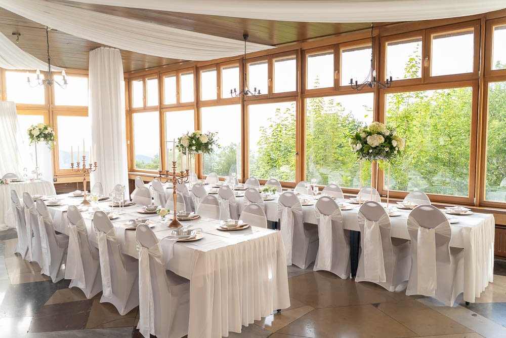 Weiß dekorierter Hochzeitssaal in der Hochzeitslocation Eventhaus Wiedenfelsen.
