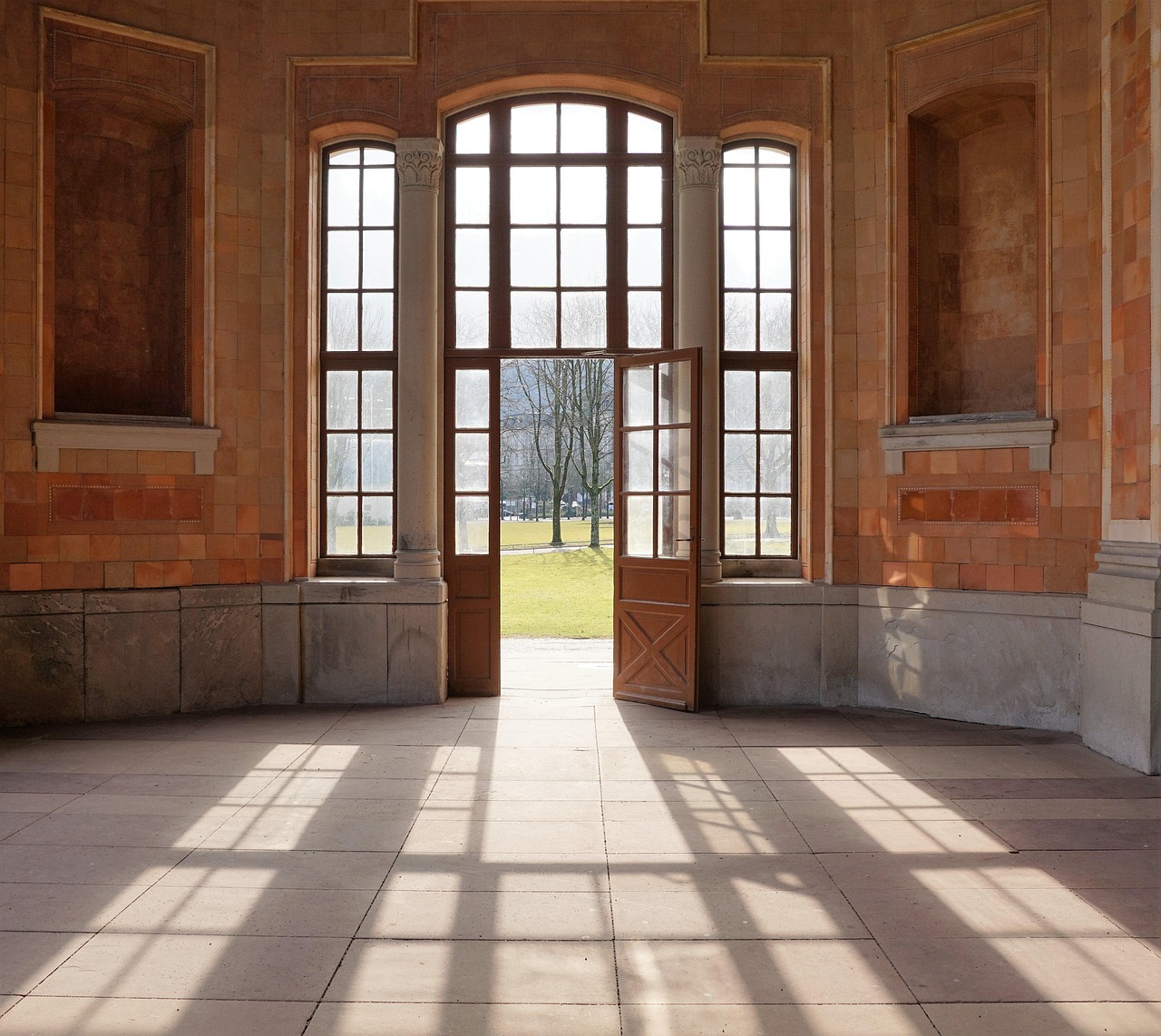 Lichtdurchfluteter Raum mit geöffneter Tür als architektonischer Rahmen für eine inszenierte Hochzeit bei Baden-Baden